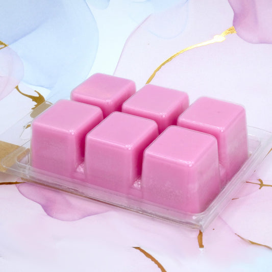 photo of pink colored wax melt container on marble background